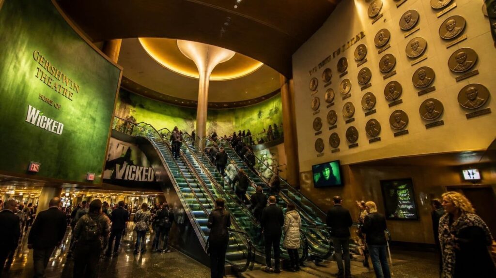 A cinematic wide-angle interior photograph of the grand rotunda lobby of the Gershwin Theatre in New York